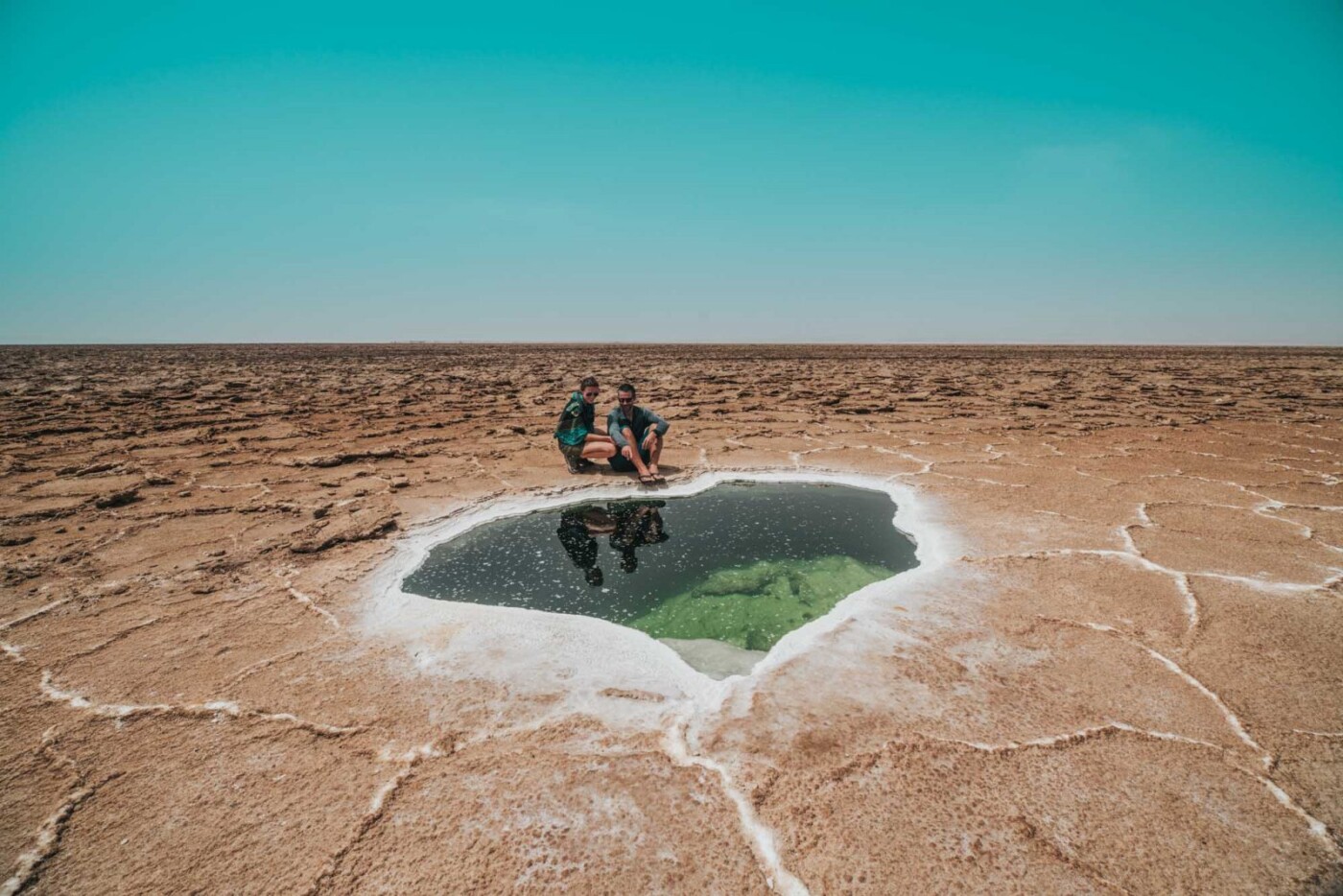 Admiring a small salt lake amidst the arid landscape of Dallol region in Danakil Depression