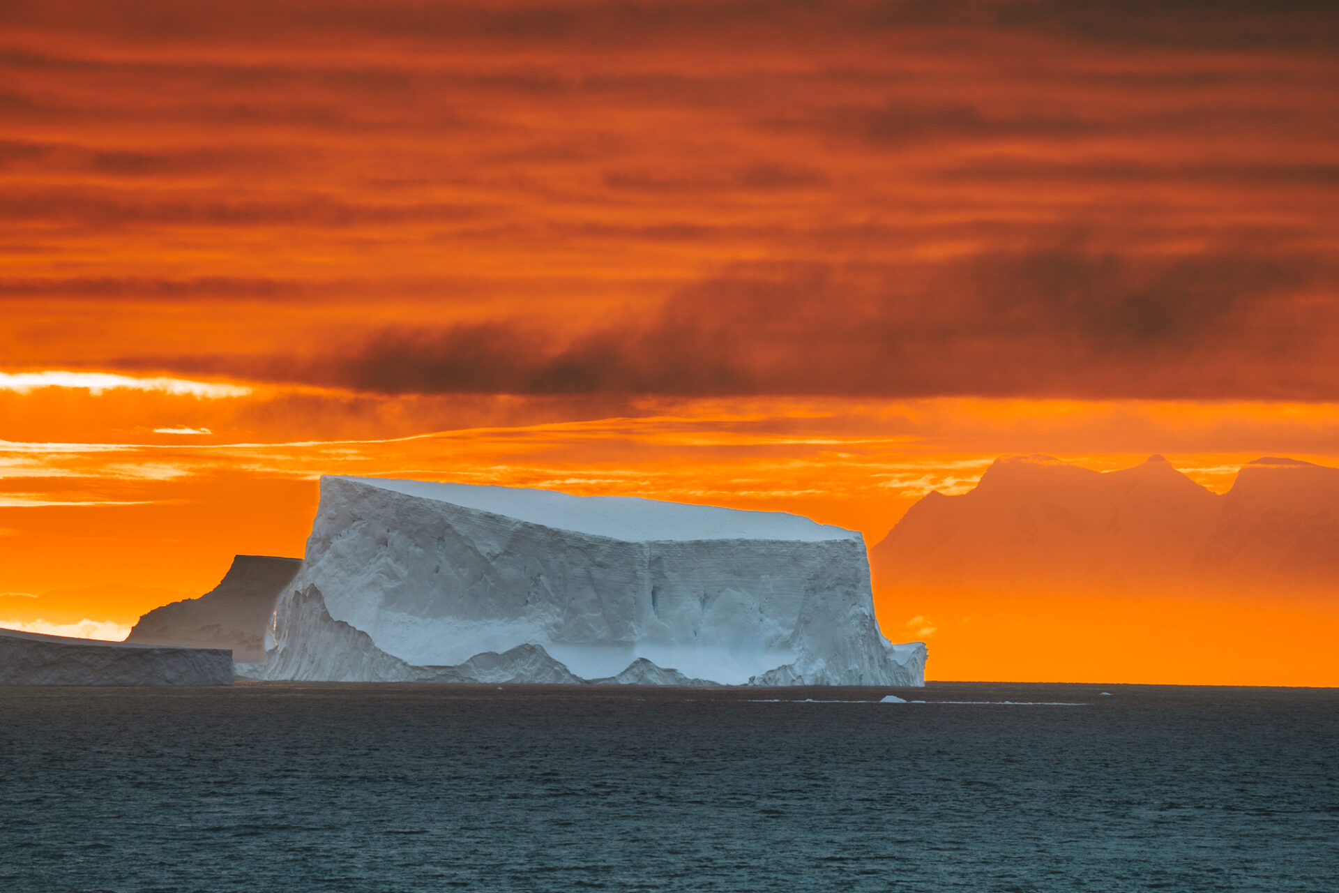 Iceberg against the fiery sky