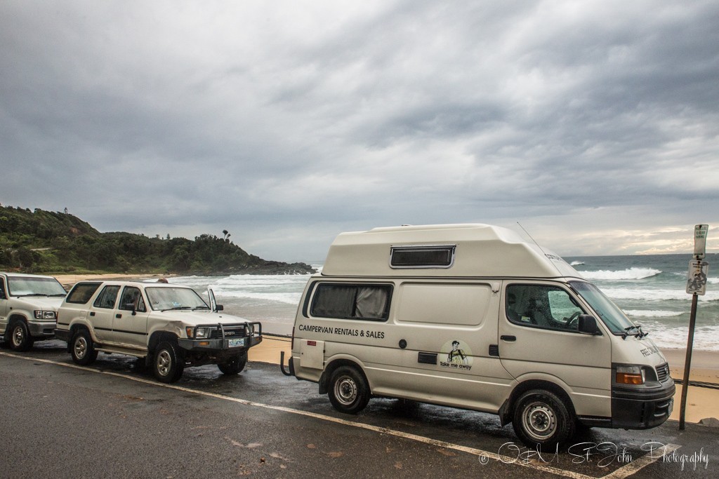 Trip to Australia cost: Campervans line Flynn's Beach in Port Macquarie, NSW