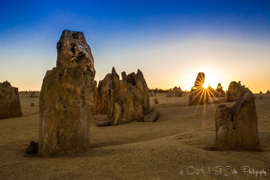 Western Australia itinerary: Sun peaking out from one of the pinnacles at the Pinnacles Desert in Cervantes. Western Australia
