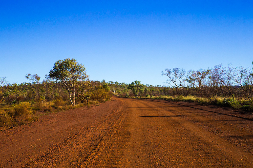 Western Australia itinerary: Unsealed red dirt road leading up to Karijini National Park. Western Australia