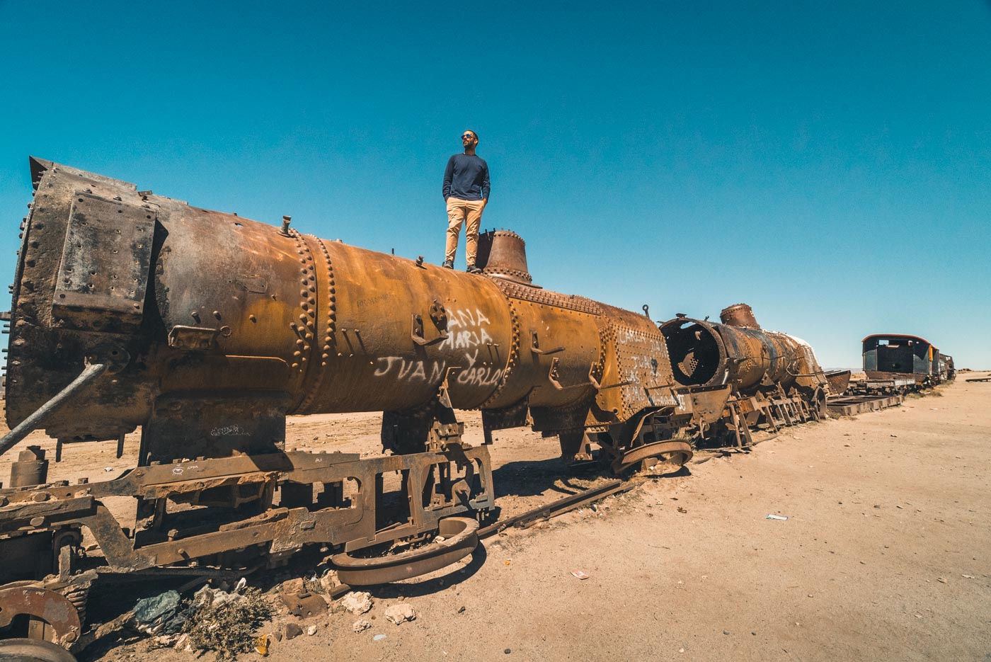 Max on top of a rusted train at the Train Graveyard outside of Uyuni