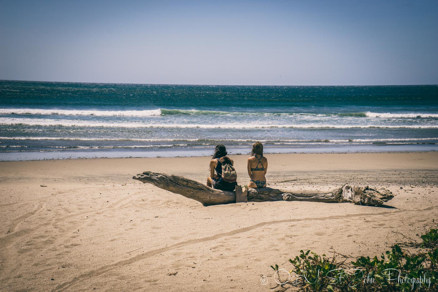 Things to do in Nosara: Two backpackers on the beach in Playa Guiones. Nosara. Costa Rica