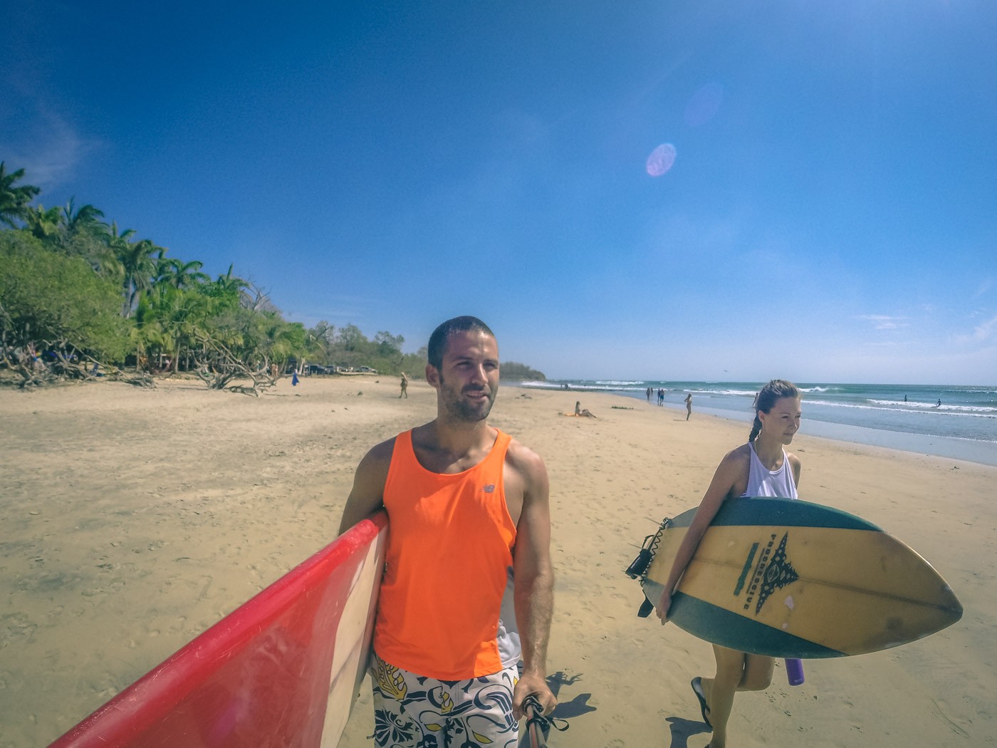 Costa Rica itinerary: Max and Oksana heading out for a surf. Playa Avellanas. Costa Rica