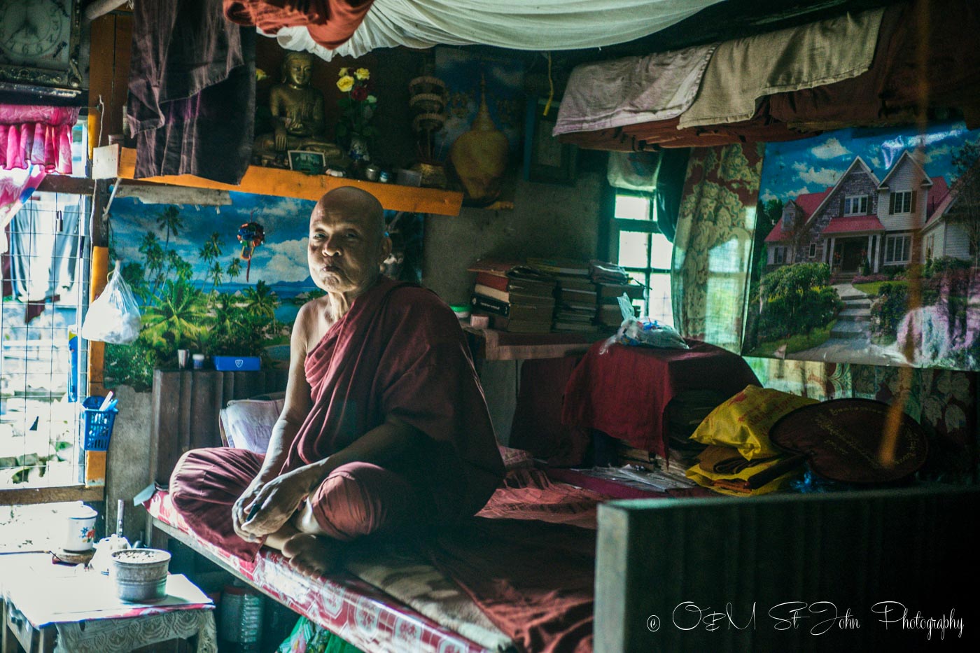 Older Burmese monk inside his living quarters in a monastery in Yangon. Myanmar