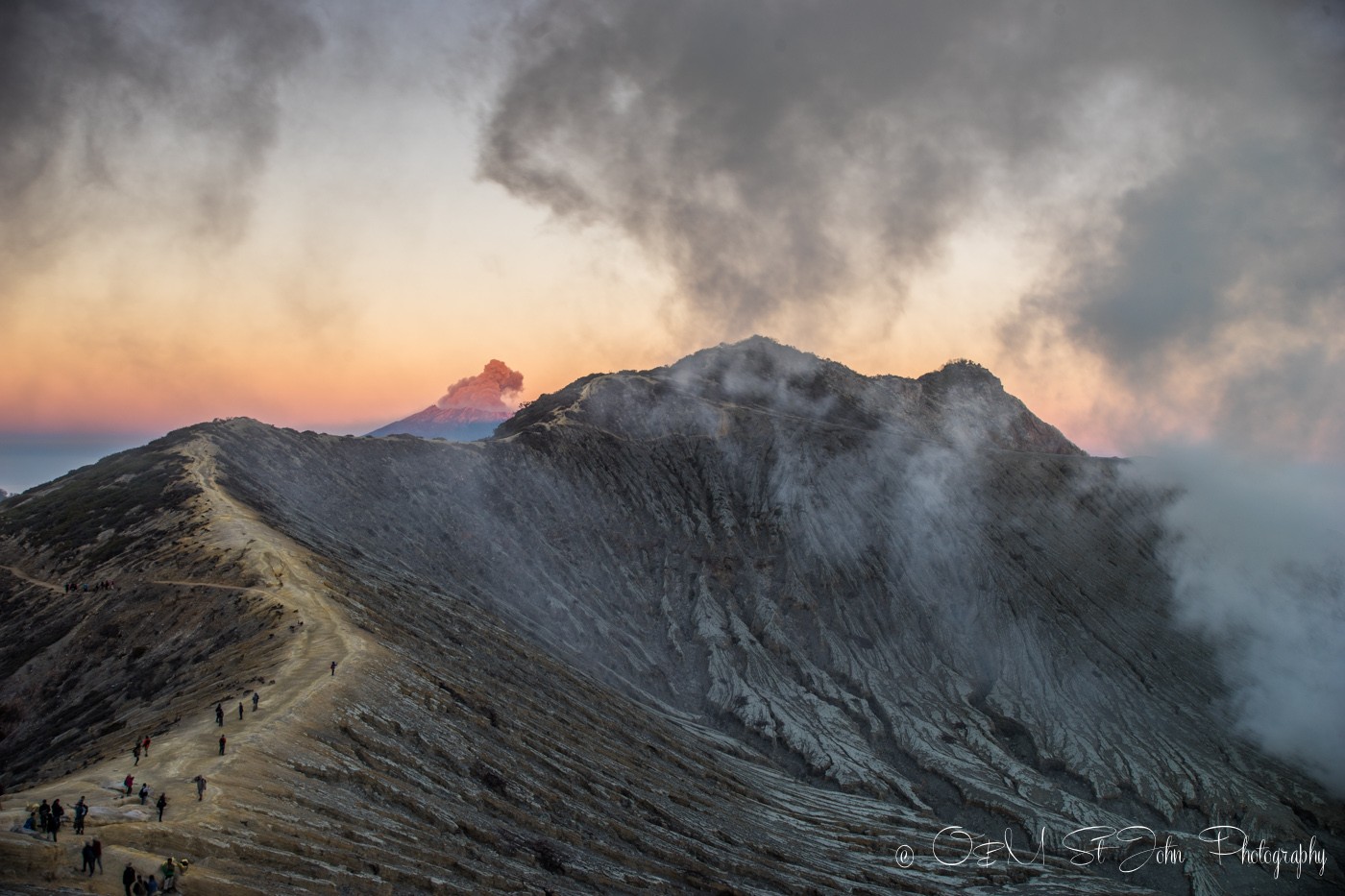 Mt Raung errupting in the distance. Ijen Crater. East Java. Indonesia