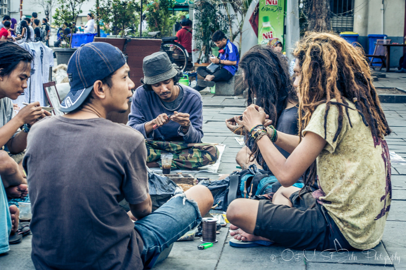 A group of rastafarians making bracelets in Taman Fatahilah, Old Jakarta