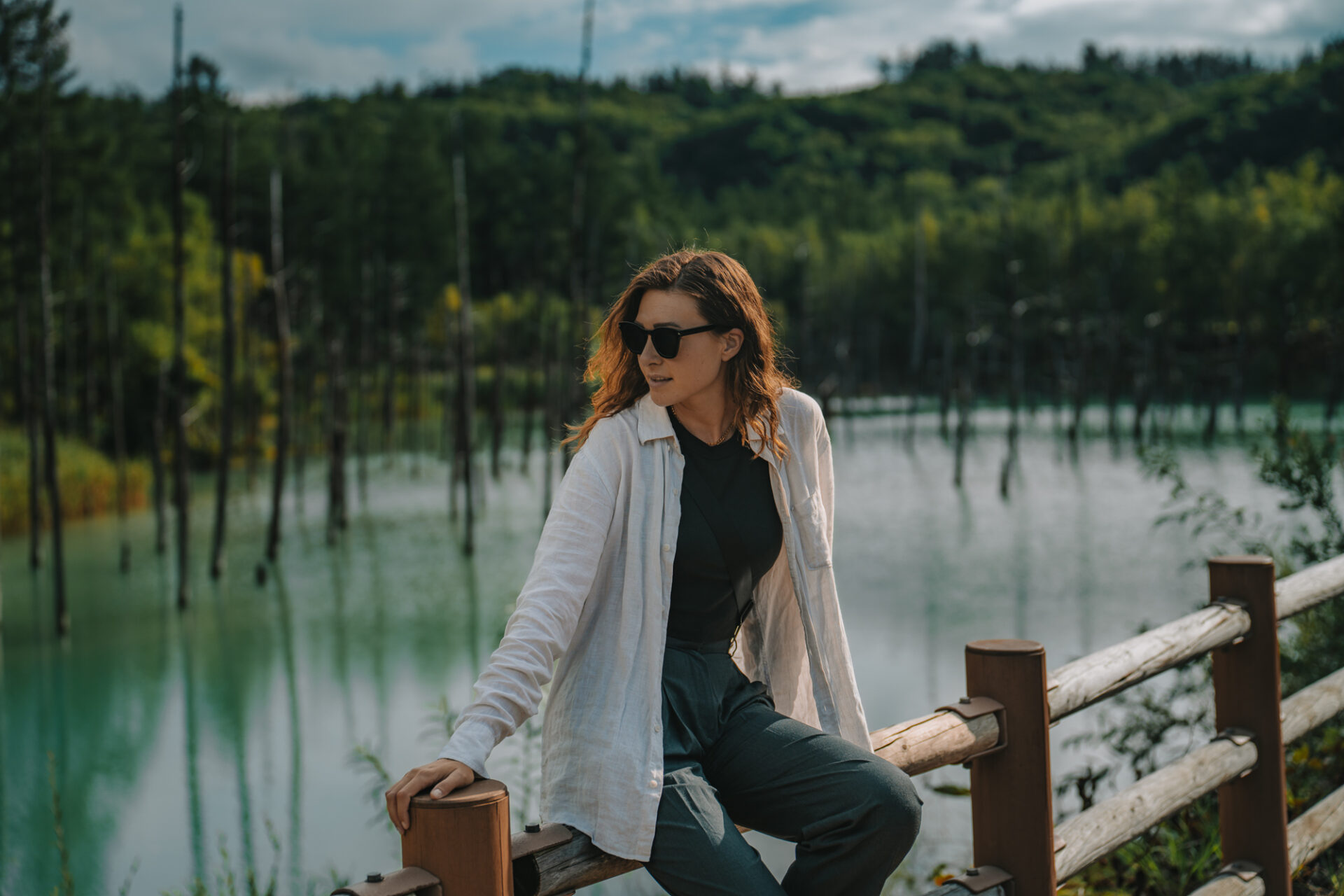 Oksana admiring the beauty of Shirogane Blue Pond