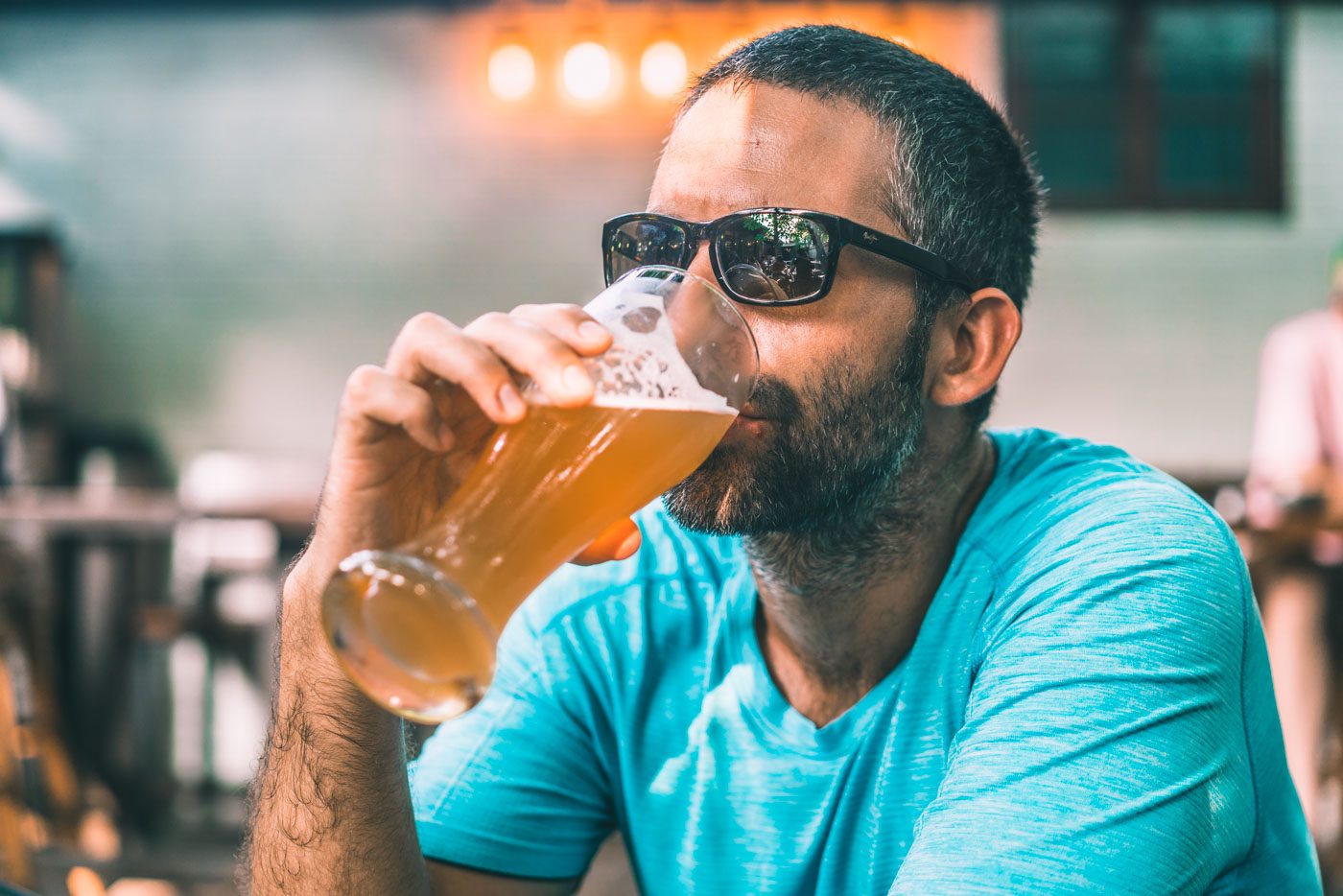 Max drinking a glass of craft beer