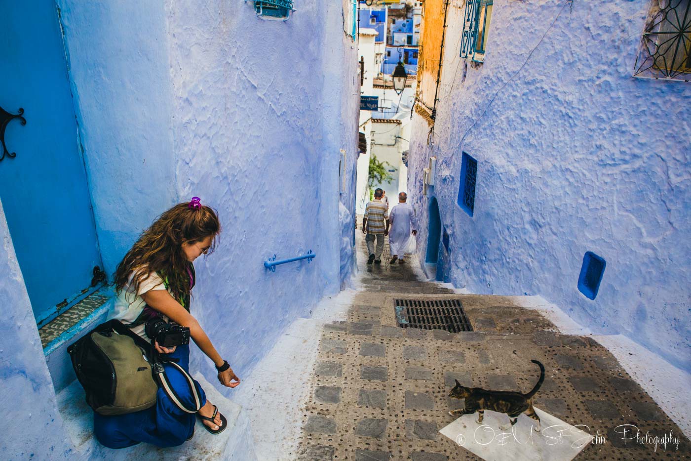 Oksana feeding cat in Chefchaouen. Morocco
