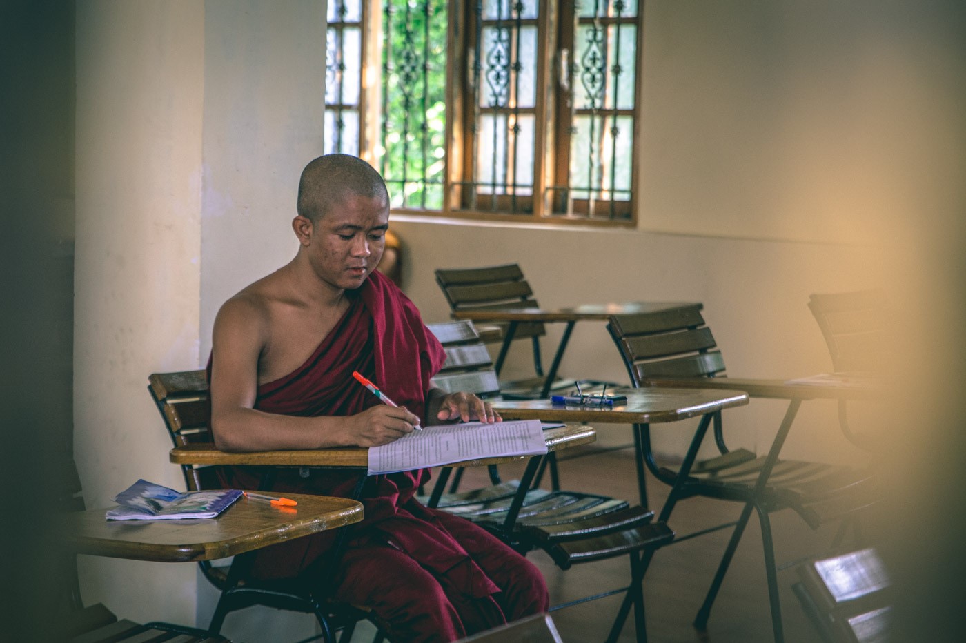 Young monk taking a math lesson at a monastery in Yangon. Myanmar 