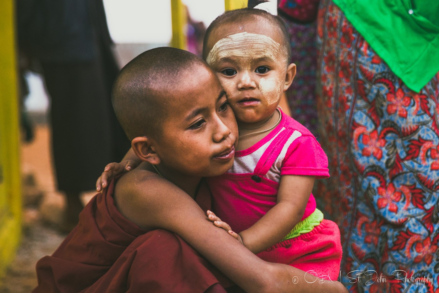 Young monk hugs their sibling at the Palaung Village Monk Harvest Festival