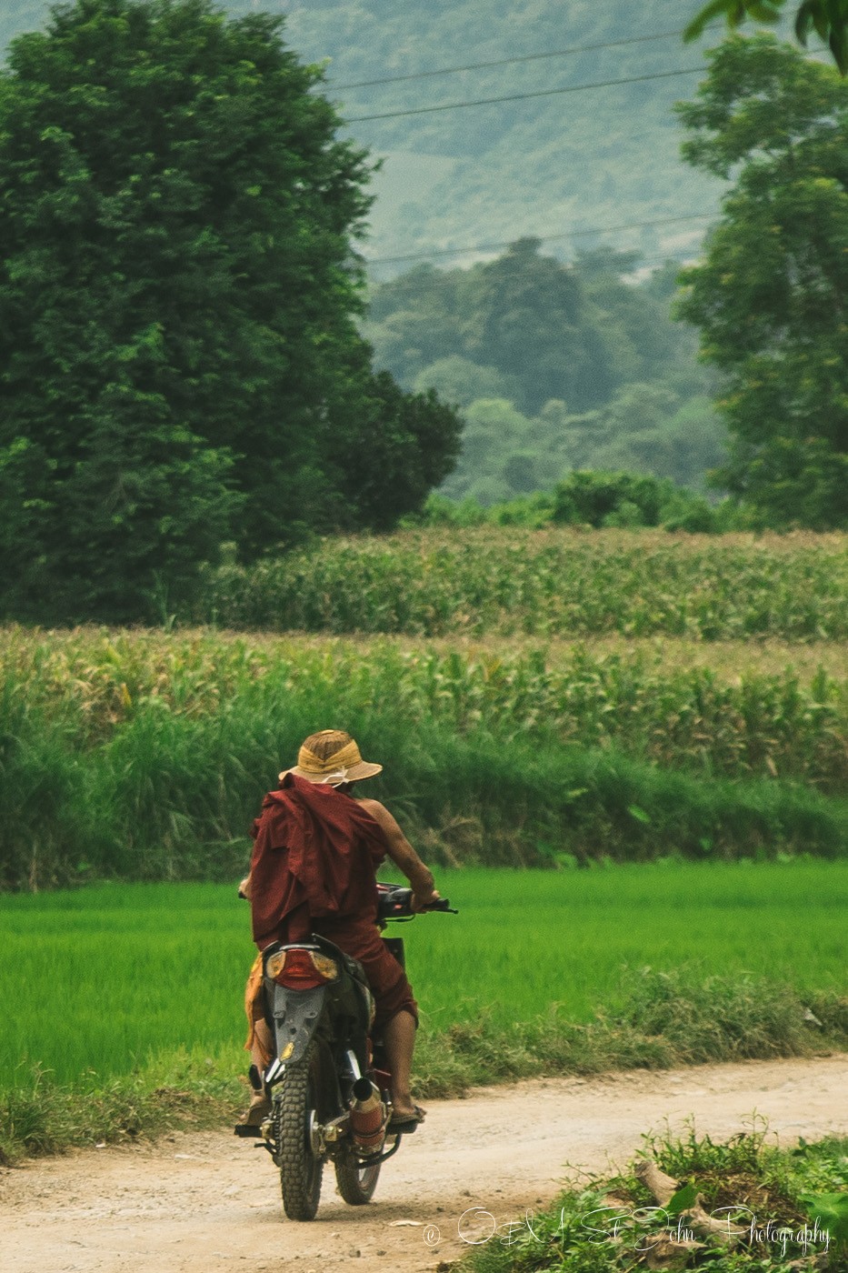 Monk on a bike in the village in Shan state. Hsipaw. Myanmar