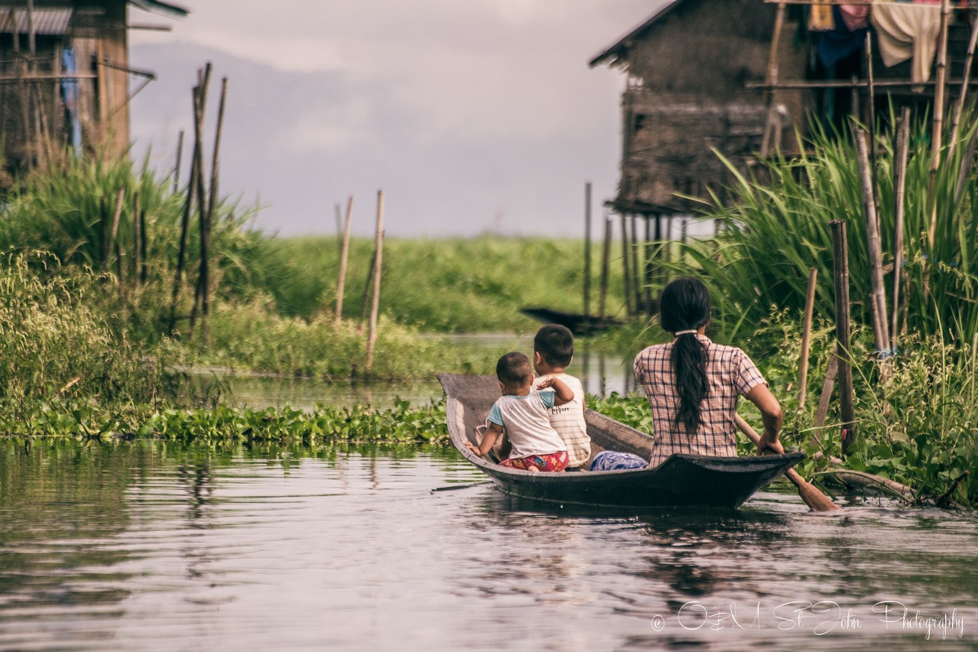 Family sails to their home in Inle Lake. Myanmar