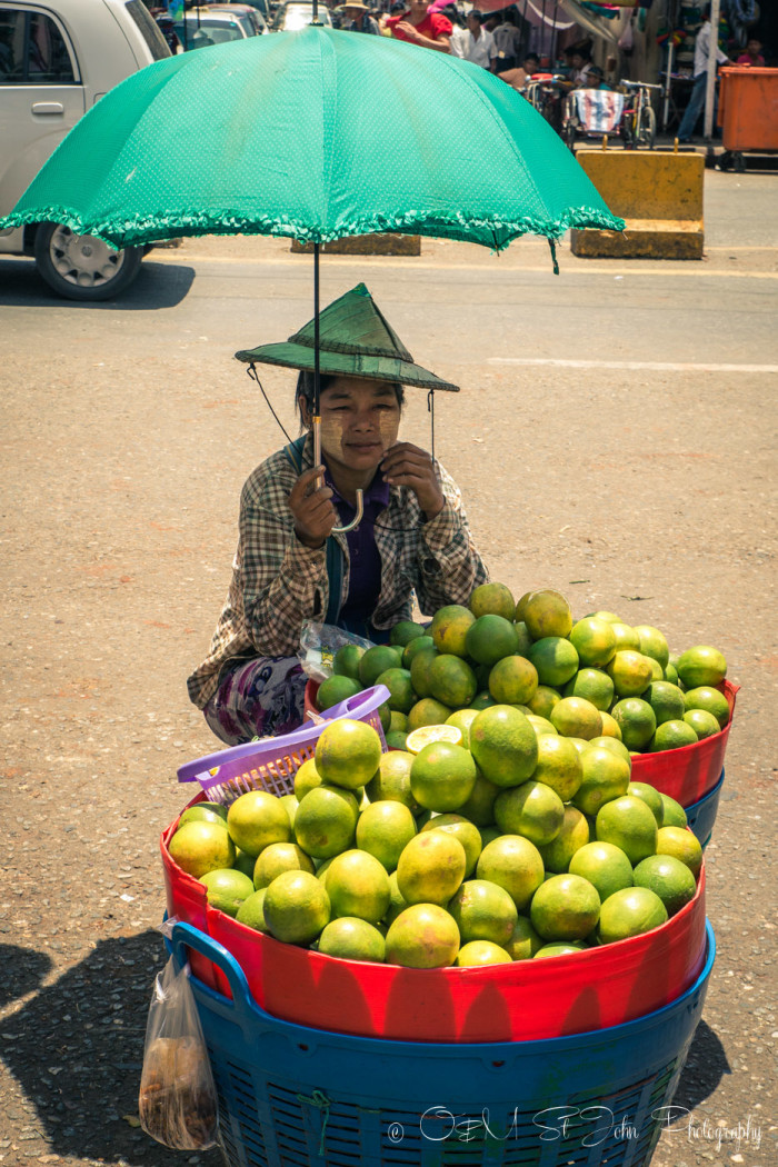 Burmese woman selling fruit at a street market in Yangon. Myanmar