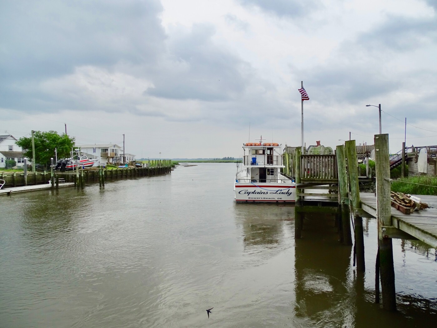 The coast of Delaware has beaches and working docks.