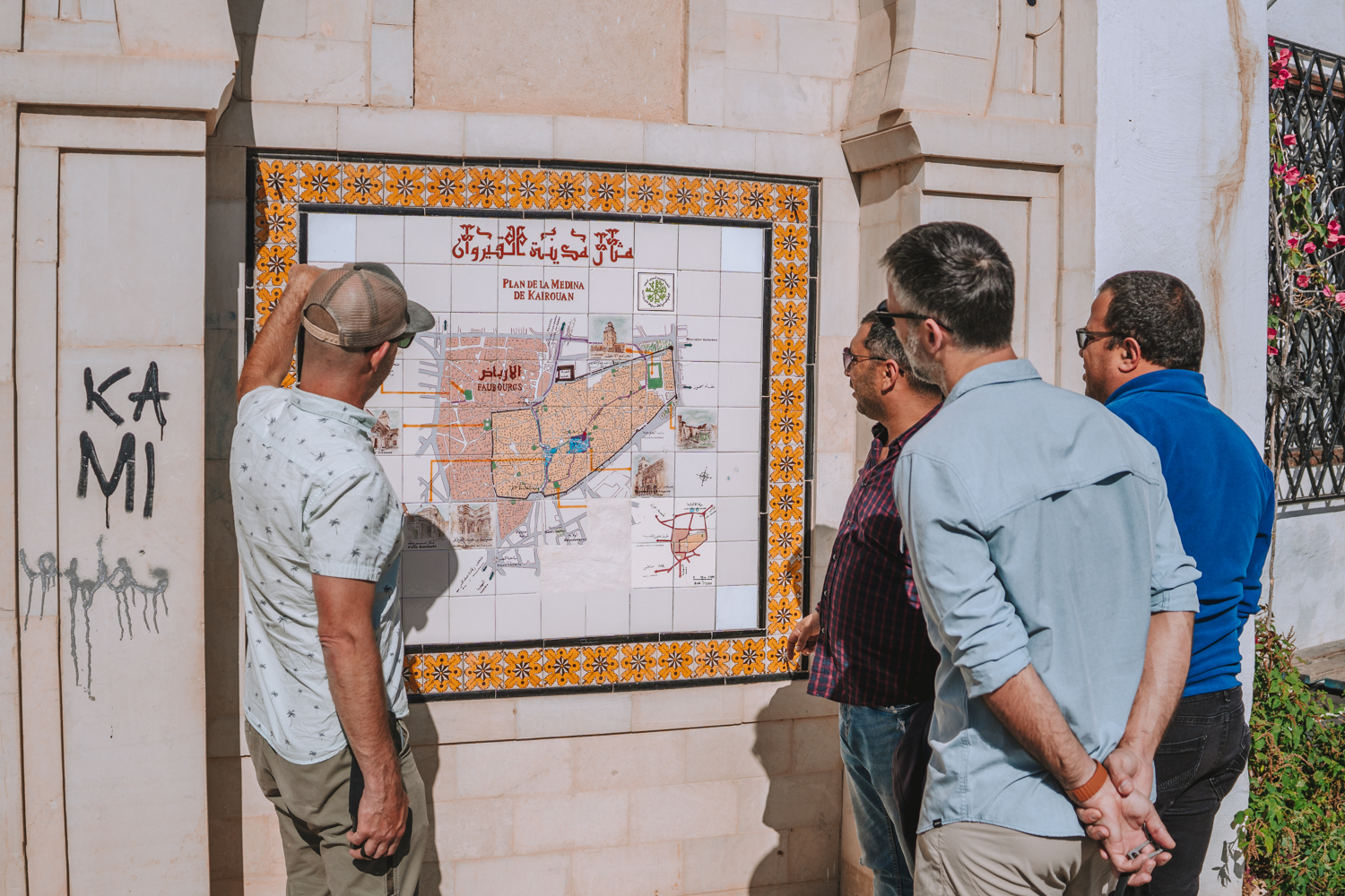 Max and other tourists looking at the map of Kairouan medina