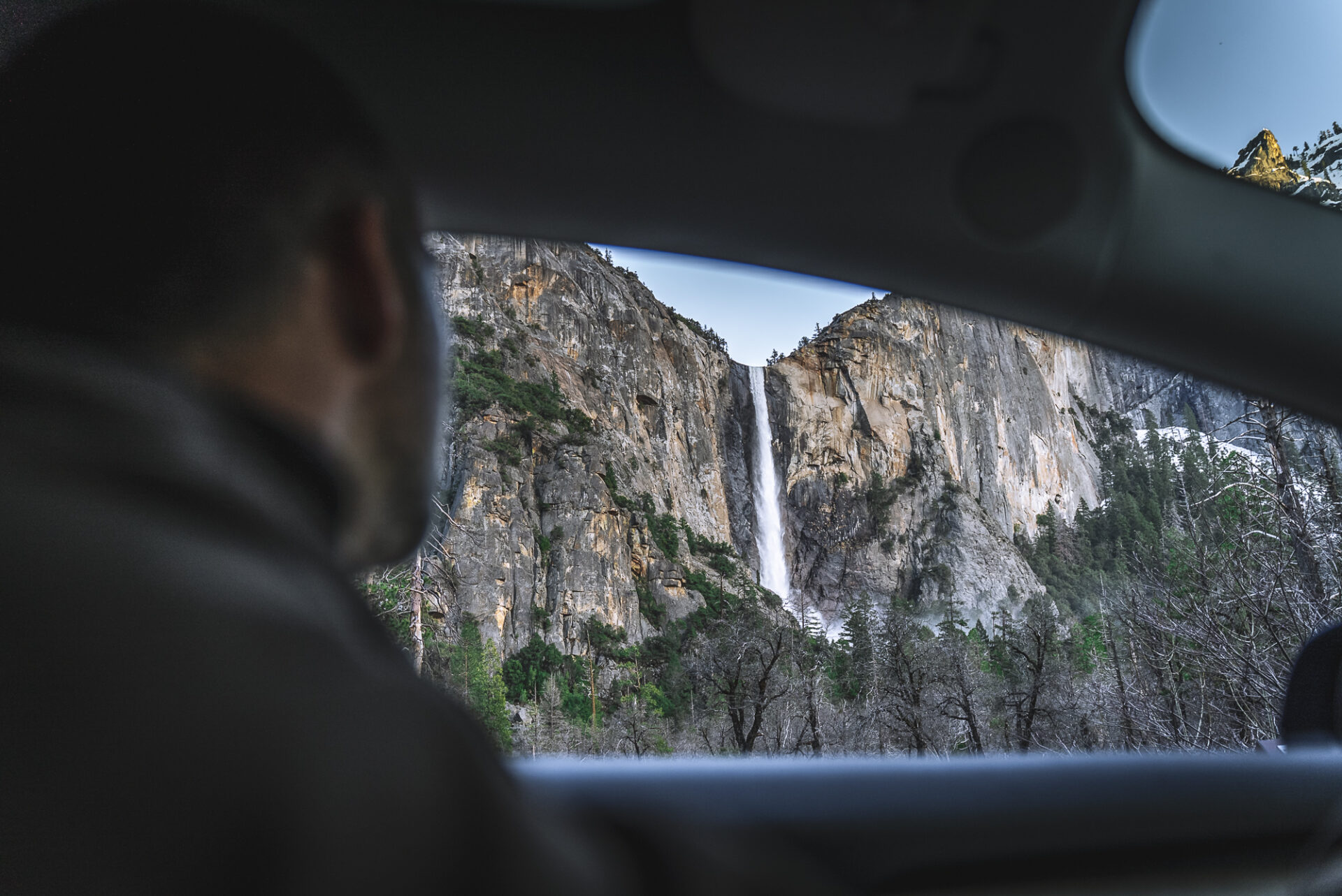 Admiring the gushing Yosemite Falls from a car window