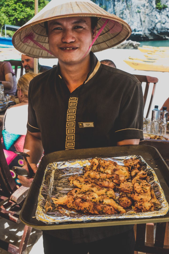 Thomas, serving us delicious sea food during BBQ lunch on a beach in Bai Tu Long Bay