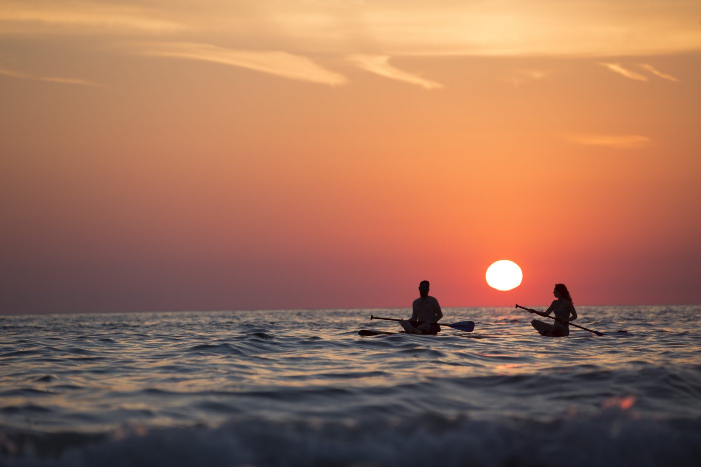 romance travel: paddling on the ocean with the sunset